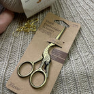 Foto af Stork guld saks og garn 